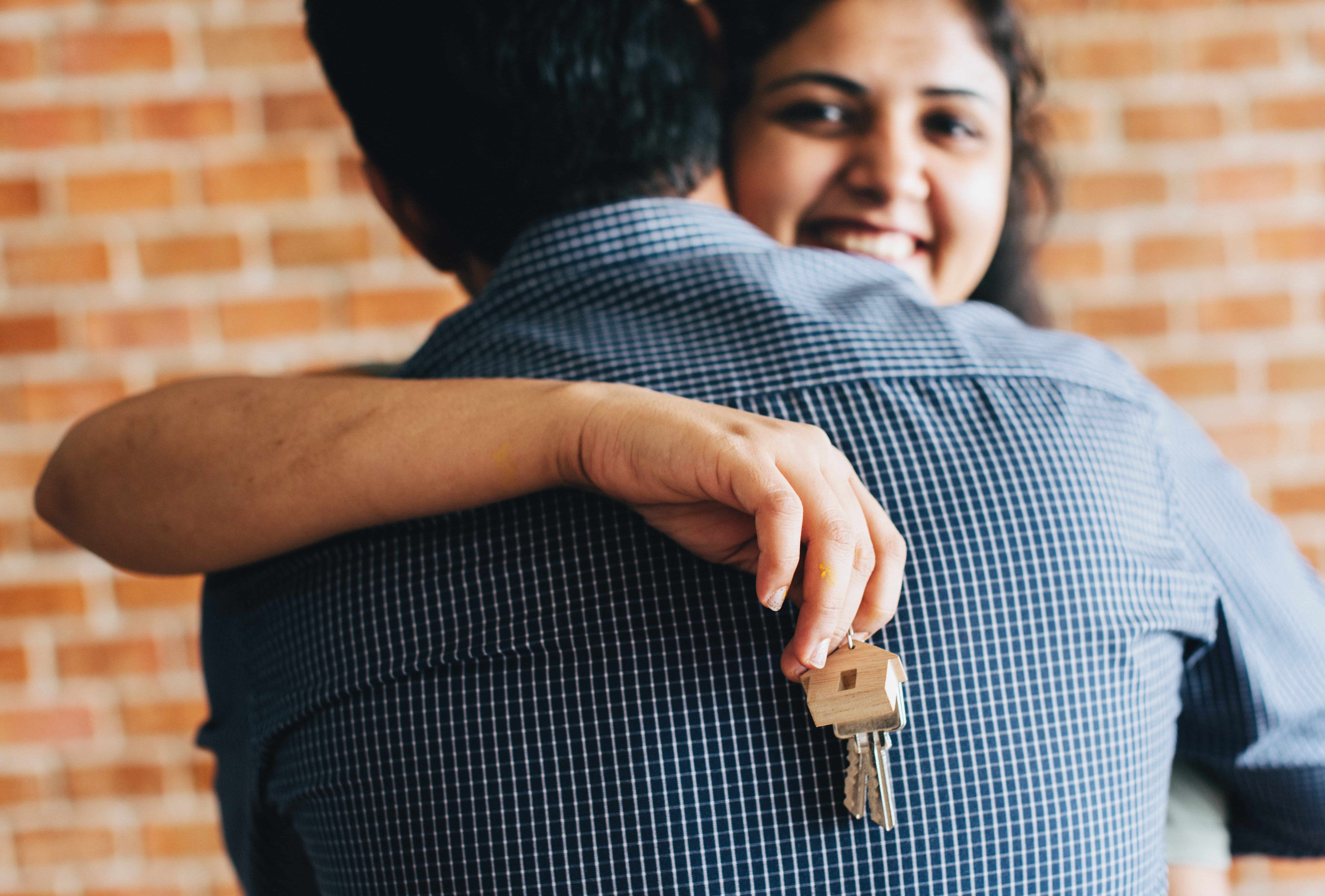 first time home buyer holding keys to new house